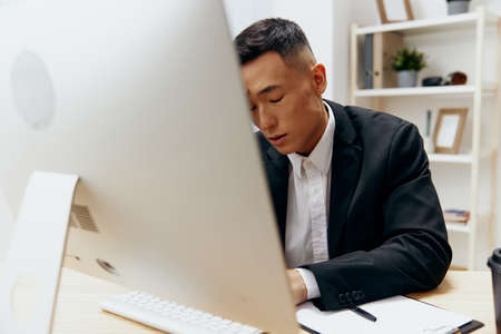 man works at the computer glass of coffee emotion office Workspaceの写真素材