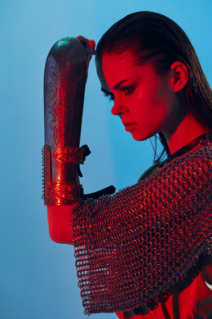 attractive woman Glamor posing red light metal armor on hand Lifestyle unalteredの写真素材