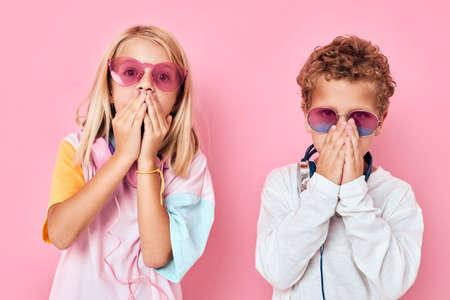Portrait of a girl and a boy blonde hair fashionable glasses Childhood lifestyle conceptの写真素材