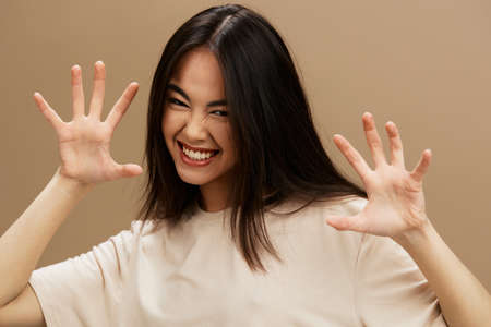 woman attractive look charmin in a t-shirt beige background