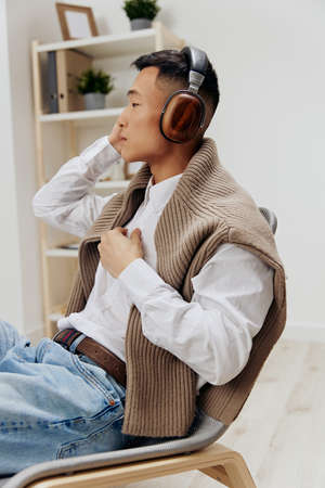 man in headphones sits on a chair rest music Lifestyleの写真素材