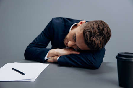 handsome businessman sitting at a desk in front of a computer technologiesの写真素材
