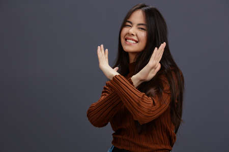 beautiful woman brown sweater glamor posing smile fashion Gray backgroundの写真素材