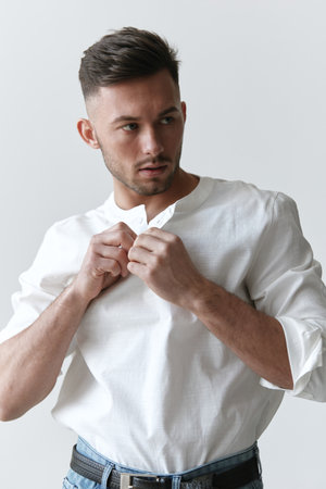 Handsome attractive serious model man guy wear linen shirt posing isolated on over white studio background. Fashion Style New Collection Sale ad concept. Copy space, banner. Model shootの写真素材