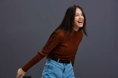 Brunette hand gestures brown sweater fashion emotions isolated background