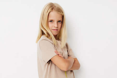 Positive little girl beige t-shirts grimace kids lifestyle conceptの写真素材