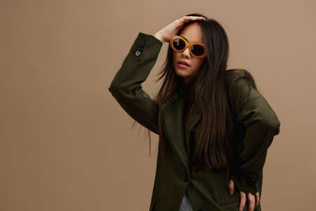 woman in a stylish suit in black glasses posing isolated background