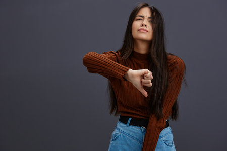 woman hand gestures brown sweater fashion Gray background