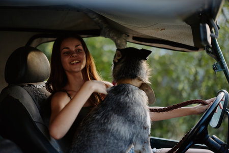 Woman and her husky dog happily traveling in car smile with teeth autumn walk with pet, travel with...