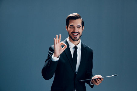 Portrait of a business man in a stylish suit smile with teeth with a tie beautiful face on a blue...