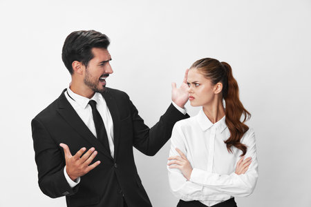 Man and woman anger business in business at each other shouting with their hands up in the air...