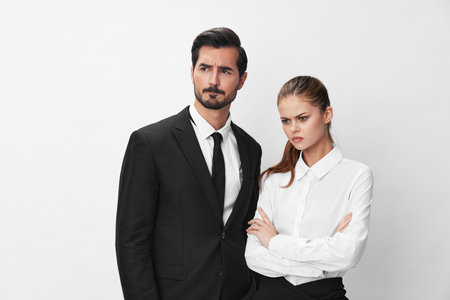 Man and woman anger business hitting on each other screaming with their hands up in the air on a white isolated background. The concept of business in a couple harassment startup copy spaceの写真素材