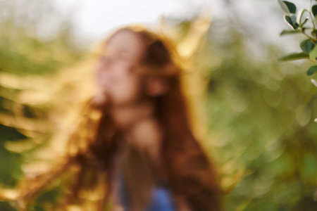 Portrait out of focus blurred women with long flying hair red hair in summer, the concept of health...