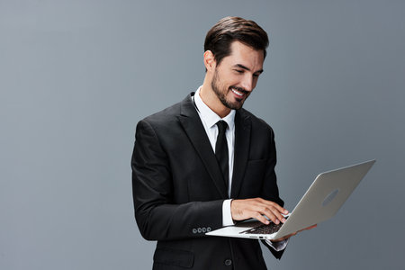 Man business with laptop smile with teeth business talks online internet by video call on gray background. Happiness from cooperationの写真素材