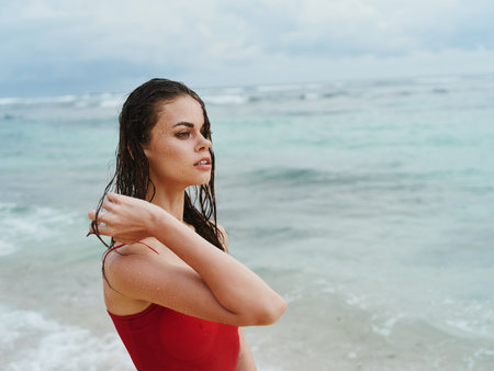 Beautiful woman on the beach by the seaの写真素材