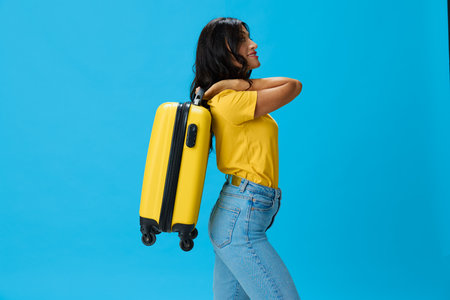 Travel woman with yellow suitcase, passport and ticket in hand, paper plane, in yellow T-shirt on...