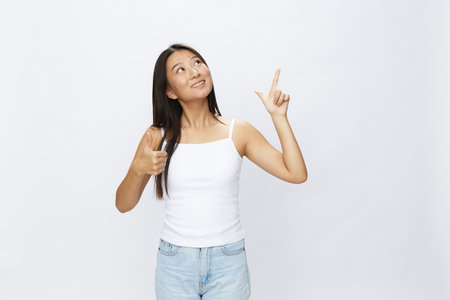 Asian woman hand signals, finger pointing facial skin problems, acne and inflammation, red rash and allergies, chicken pox, sadness from rashes. Facial skin care concept for diseases and nervesの写真素材