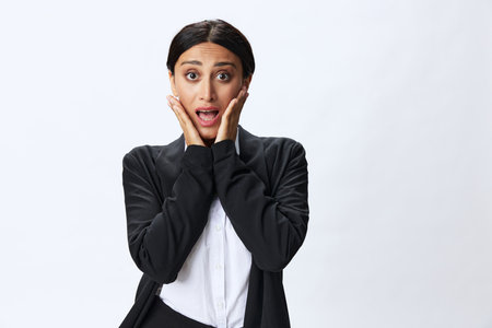 Business woman in black business suit shows signals gestures and emotions on white background, freelancer job online time management, teacher scienceの写真素材