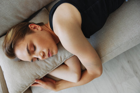 Young woman with short haircut hair having fun at home on the couch smile and happiness, vacation at home, natural posing without filters, free copy spaceの写真素材