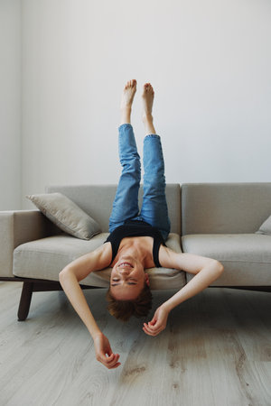 Young woman with short haircut hair having fun at home on the couch smile and happiness, vacation at...