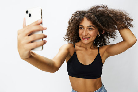 Woman blogger with phone in hand on white background selfies, video call, freelancer influencer job...