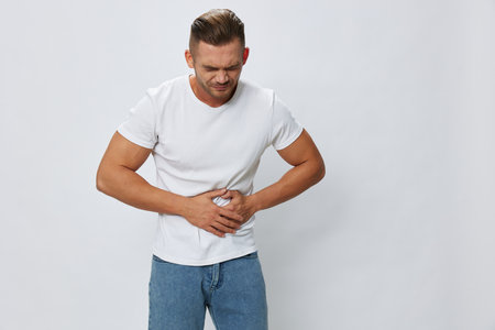 Man abdominal pain, gastritis and appendicitis inflammation, in white T-shirt on white isolated...