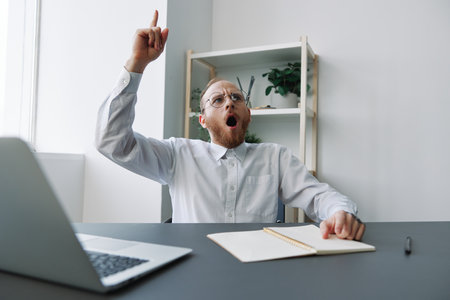 A man in a wheelchair a businessman in the office works, severe fatigue and emotional burnout, anger, integration into society, the concept of work a person with disabilitiesの写真素材