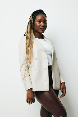 African american business woman portrait, business clothes and jacket with afro pigtails smile. White background. Soft warm colors.の写真素材