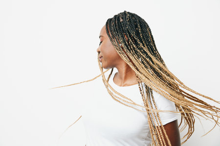 Portrait african american woman in white t-shirt smiling dancing with afro pigtails smile, flying...