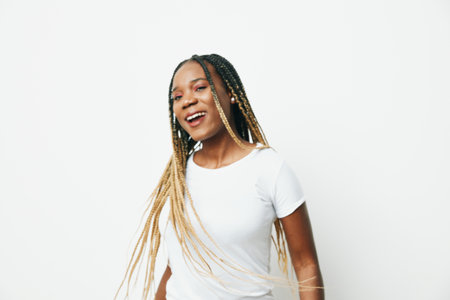 Portrait african american business woman happiness and smile dance, business clothes and jacket with afro pigtails smile. White background. Soft warm colors.の写真素材