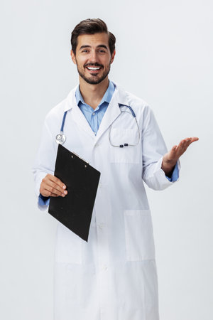 Man doctor in white coat with stethoscope and folder for notes and patient records smile and good test results on white isolated background, copy space, space for text, healthの写真素材