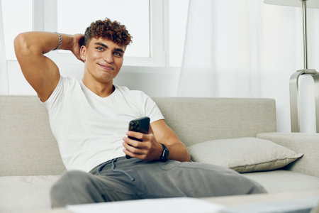 man interior message home lifestyle blogger cell cellphone freelancer teenager technologyの写真素材