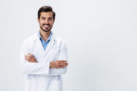 Man doctor in a white coat with a stethoscope smile with teeth and good test results looking into the camera on a white isolated background, copy space, space for text, healthの写真素材