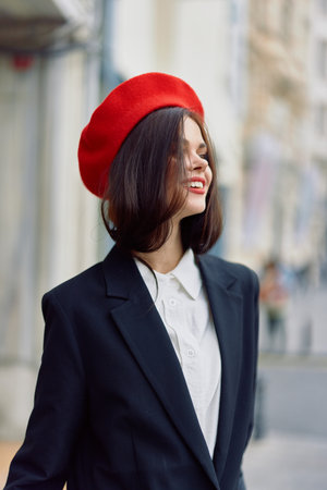 Fashion woman smile spring walking in the city in stylish clothes with red lips and red beret, travel, cinematic color, retro vintage style, urban fashion lifestyle.の写真素材