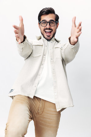 Man portrait in glasses smile with teeth joy on a white isolated background, fashionable clothing style, copy space, space for textの写真素材
