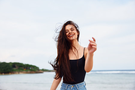 running woman smile travel sunset water summer beach sea young lifestyleの写真素材