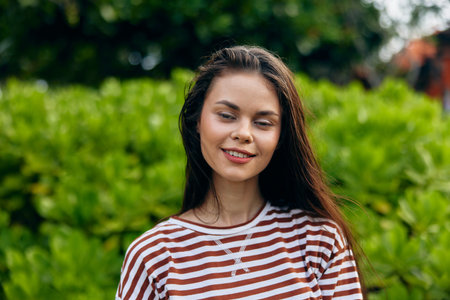 smiling woman park relax nature lifestyle freedom t-shirt beautiful summer walkの写真素材