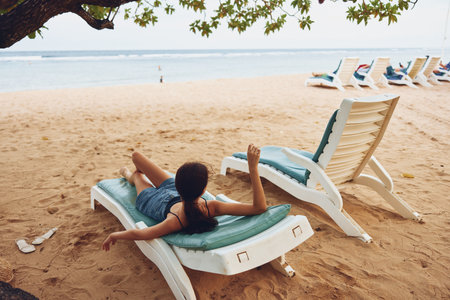 woman smiling resort sea lying ocean sunbed girl lifestyle sand beach