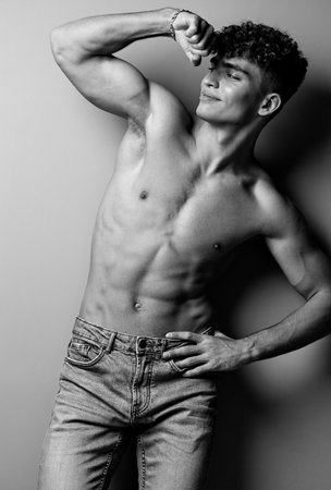 man person black and white athlete caucasian bodybuilding jeans muscular arm fashion fitness strong blackの写真素材