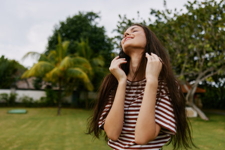 woman summer freedom lifestyle hipster beautiful nature park walk t-shirt smilingの写真素材