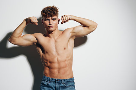 man strong person jeans guy fit white background attractive healthy adult gray background athleticの写真素材