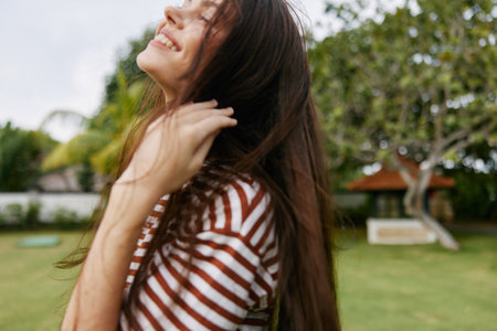 freedom woman nature walk park summer lifestyle smiling sunset t-shirt beautifulの写真素材