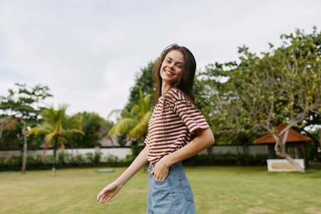 woman smiling lifestyle freedom park nature summer walk exercise beautiful t-shirtの写真素材