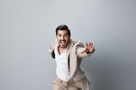 man businessman winner running business hand happy suit victory beige adultの写真素材