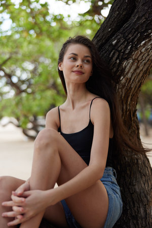 woman nature sitting relax looking lifestyle sky sea smiling vacation treeの写真素材