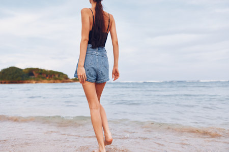 smile woman young lifestyle hair travel sea running summer sunset beachの写真素材