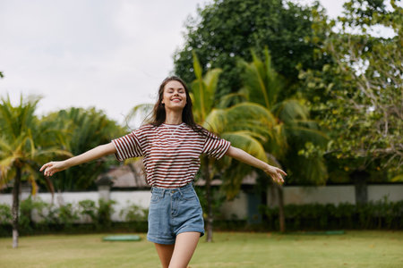 lifestyle woman summer walk t-shirt freedom park beautiful quiet smiling natureの写真素材