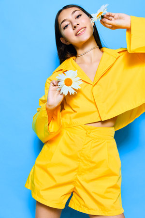 smile woman female flower model young happiness portrait yellow chamomile blueの写真素材