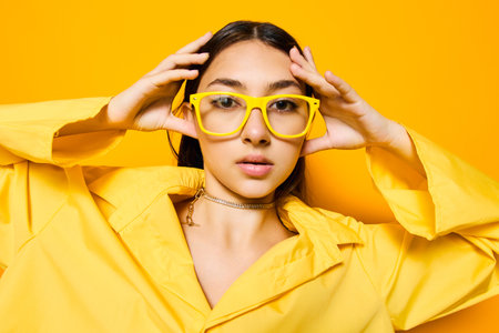 girl woman trendy glasses attractive isolated yellow fashion beautiful young lifestyleの写真素材