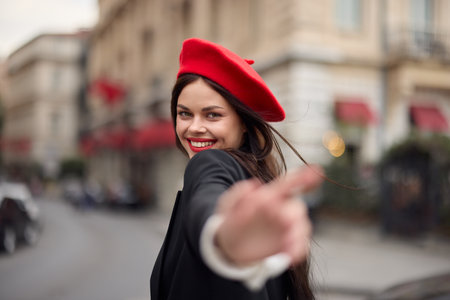 Fashion woman smile with teeth standing on the street in front of the city tourist follow me stylish clothes with red lips and red beret, travel, cinematic color, retro vintage style, urban fashion.の写真素材